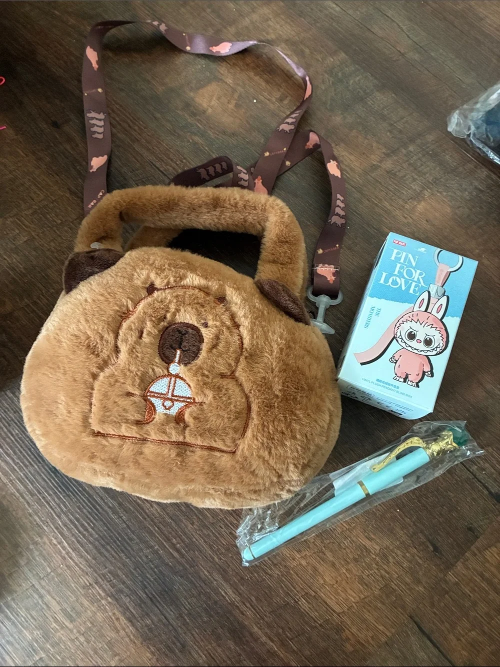 Popmart The Monsters Keychain and a unbranded capybara plush crossbody with pen